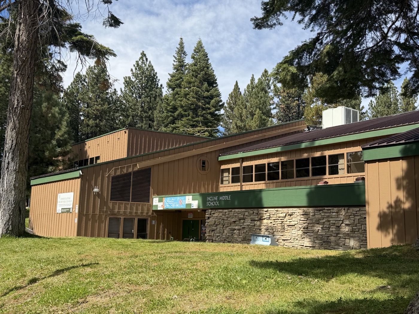 Incline Middle School, a wood and stone building surrounded by tall pines in Incline Village