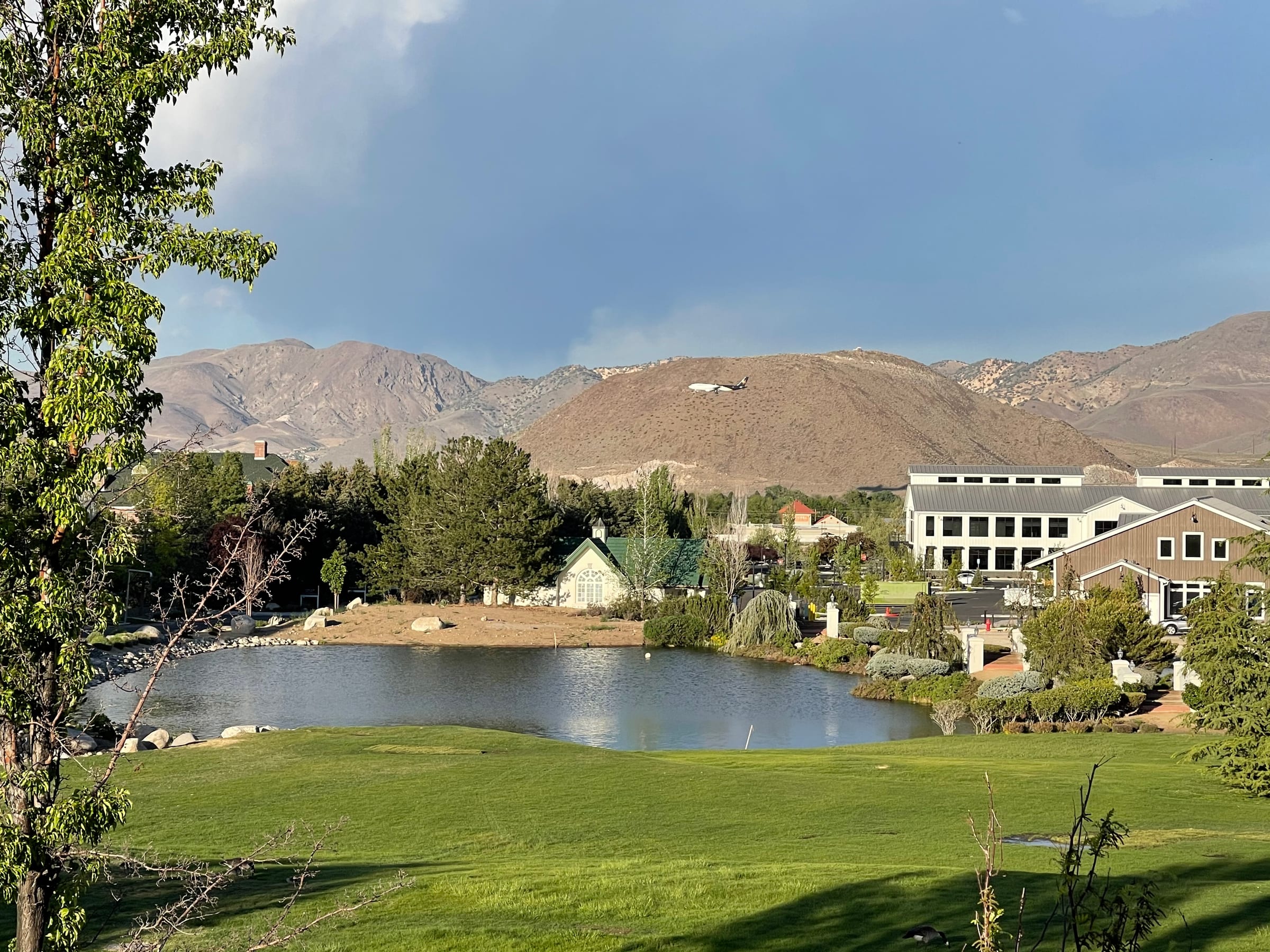 View from Rancharrah toward The Villages, with the pond, clubhouse, and mountains