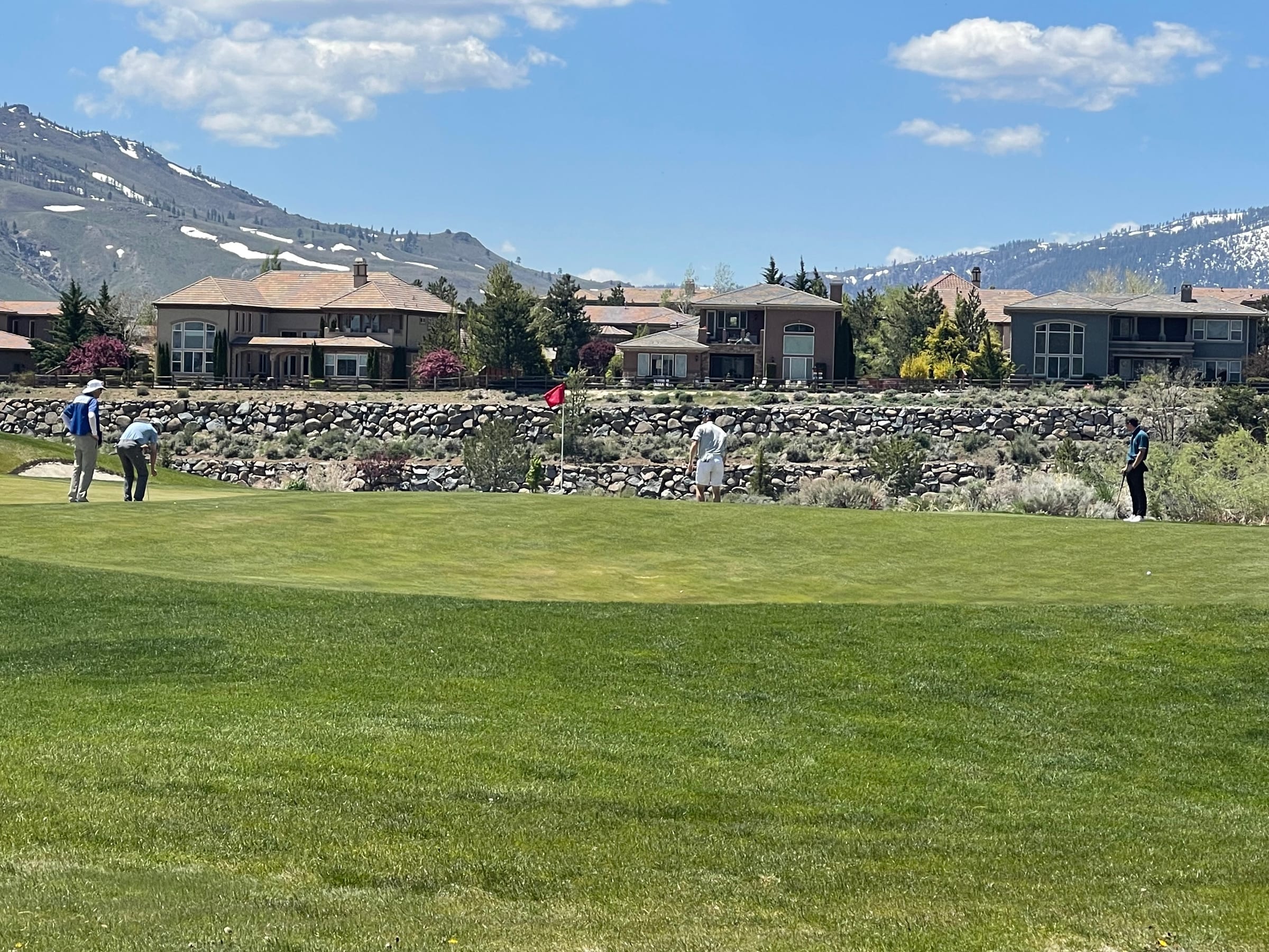 A golfer on the green at Somersett Golf and Country Club, with mountain views